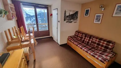 a living room with a couch and a window at Studio Vue Montagne, Skis aux pieds, Garage inclus in Samoëns