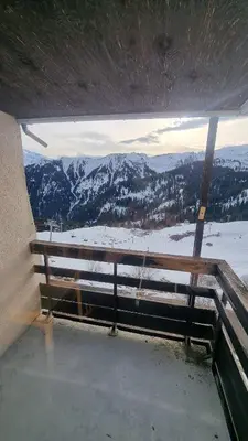 a view of a snow covered mountain from a window at Studio Vue Montagne, Skis aux pieds, Garage inclus in Samoëns