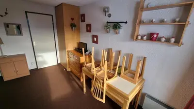 a dining room with a table and chairs at Studio Vue Montagne, Skis aux pieds, Garage inclus in Samoëns
