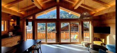 a large room with a large window in a cabin at Chalet des Ours - 2 appartements 4 étoiles premium - 5 ou 6 personnes in Les Contamines-Montjoie