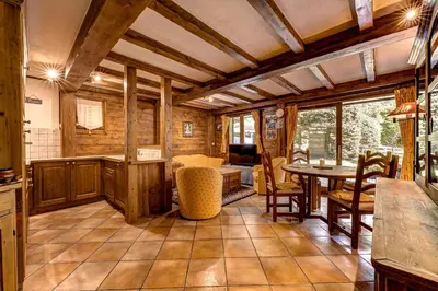 a kitchen and dining room with a table and chairs at Jardin du Parc Mont Blanc- Alpine Style apartment in the Heart of Chamonix in Chamonix-Mont-Blanc