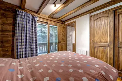 a bedroom with a bed and a window at Jardin du Parc Mont Blanc- Alpine Style apartment in the Heart of Chamonix in Chamonix-Mont-Blanc