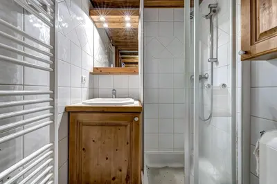 a bathroom with a sink and a shower at Jardin du Parc Mont Blanc- Alpine Style apartment in the Heart of Chamonix in Chamonix-Mont-Blanc