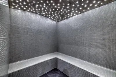 a bathroom with a tub with lights on it at Alto in Combloux