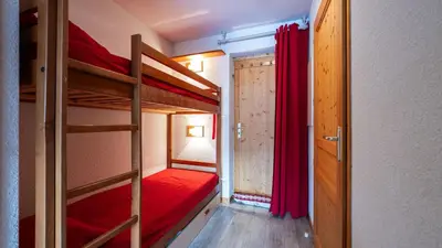a small room with two bunk beds and a doorway at Les Eterlous N35 - 2P4 in Morillon