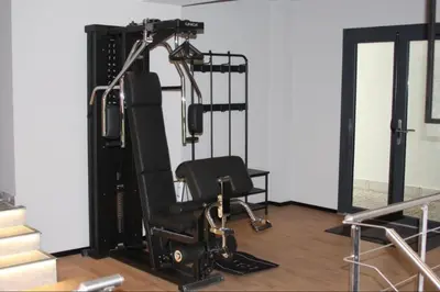 a room with a gym with a chair at CHAMONIX Résidence La Cordée avec Piscine et Spa - Appartement 126 in Chamonix-Mont-Blanc