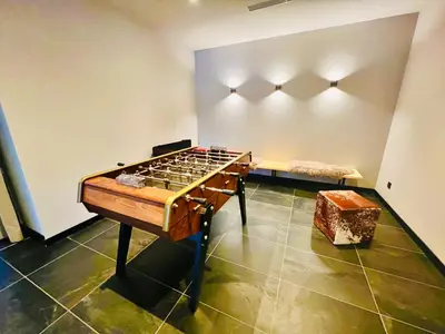 a game room with a table and a bench at CHAMONIX Résidence La Cordée avec Piscine et Spa - Appartement 126 in Chamonix-Mont-Blanc