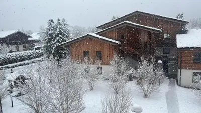 a house covered in snow with trees in front of it at CHAMONIX Résidence La Cordée avec Piscine et Spa - Appartement 126 in Chamonix-Mont-Blanc