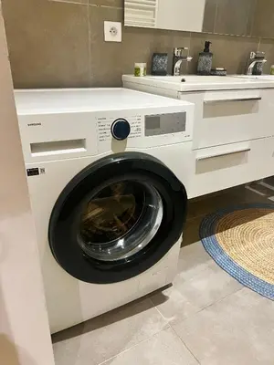 a washing machine in a kitchen with a counter at CHAMONIX Résidence La Cordée avec Piscine et Spa - Appartement 126 in Chamonix-Mont-Blanc