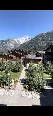 a group of houses with mountains in the background at CHAMONIX Résidence La Cordée avec Piscine et Spa - Appartement 126 in Chamonix-Mont-Blanc