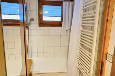 a bathroom with a shower and a window at Apartment In Downtown Chamonix in Chamonix-Mont-Blanc
