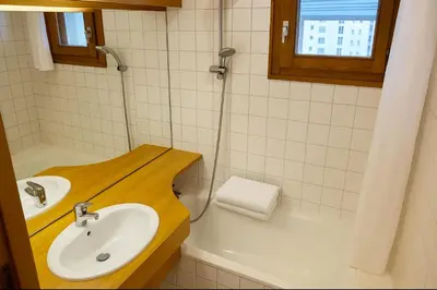 a small room with a table and a window at Apartment In Downtown Chamonix in Chamonix-Mont-Blanc