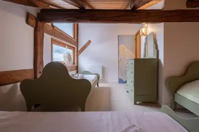 a bedroom with a white bed with two towels on it at Duplex T3 with terrace in Chamonix in Chamonix-Mont-Blanc
