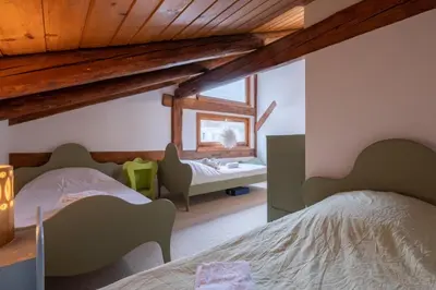 a bedroom with two beds and a dresser in it at Duplex T3 with terrace in Chamonix in Chamonix-Mont-Blanc