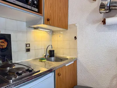 a small kitchen with a sink and a stove at Charmant Studio Avec Terrasse By TerraAlpina in Saint-Gervais-les-Bains