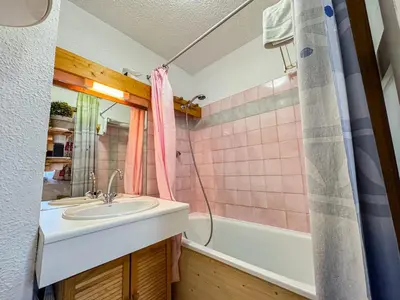 a bathroom with a sink and a bath tub at Charmant Studio Avec Terrasse By TerraAlpina in Saint-Gervais-les-Bains