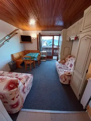 a room with a couch and a table in a room at Appartement Cosy in Les Carroz d'Araches