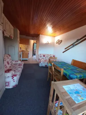 a living room with a table and a couch at Appartement Cosy in Les Carroz d'Araches