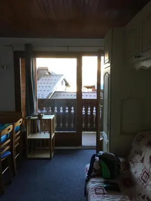 a living room with a view of a balcony at Appartement Cosy in Les Carroz d'Araches