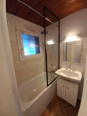 a bathroom with a tub and a sink and a shower at Appartement Cosy in Les Carroz d'Araches