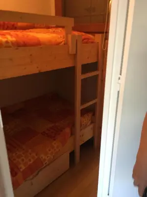 two bunk beds in a room with a closet at Appartement Cosy in Les Carroz d'Araches