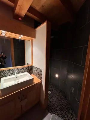 a bathroom with a sink and a mirror at Appartement duplex megeve in Megève