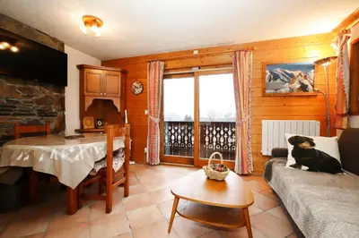 a living room with a dog sitting on a couch at Résidence Les Hauts De Chavants - Hauts de chavants Albert 1er n°3 MAE-2651 in Les Houches
