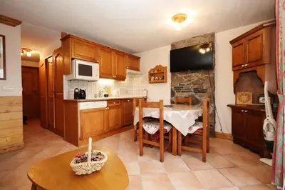 a kitchen with wooden cabinets and a table and a tableablish at Résidence Les Hauts De Chavants - Hauts de chavants Albert 1er n°3 MAE-2651 in Les Houches