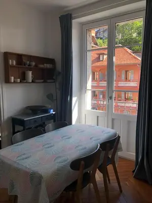 a table and chairs in a room with a window at La Residence, Beautiful Comfort in Saint-Gervais-les-Bains