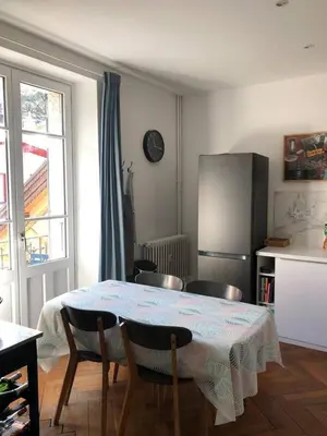 a kitchen with a table and chairs and a refrigerator at La Residence, Beautiful Comfort in Saint-Gervais-les-Bains