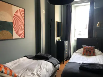 a bedroom with two beds and a window at La Residence, Beautiful Comfort in Saint-Gervais-les-Bains