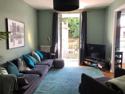 a living room with a couch and a television at La Residence, Beautiful Comfort in Saint-Gervais-les-Bains