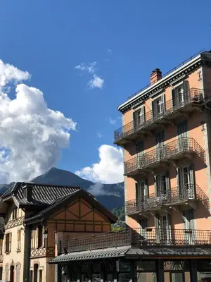 a building with balconies and a mountain in the background at La Residence, Beautiful Comfort in Saint-Gervais-les-Bains