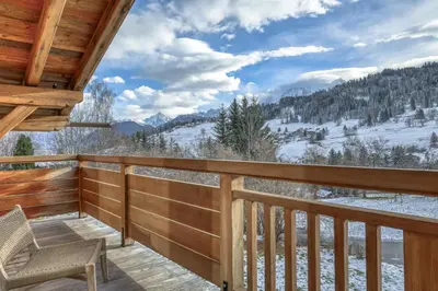 a balcony with a view of the snow covered mountains at Chalet Ascension in Combloux