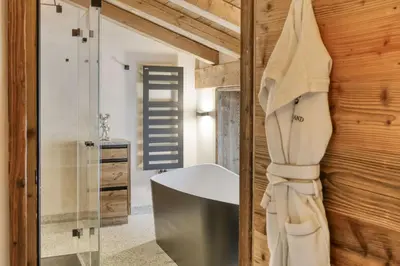 a bathroom with a sink and a bath tub at Chalet Ascension in Combloux