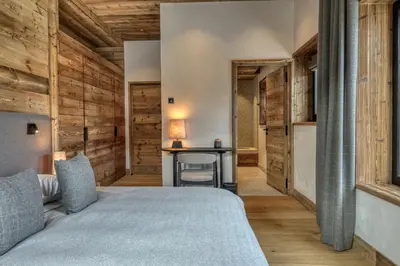 a bedroom with a bed and a desk at Chalet Ascension in Combloux