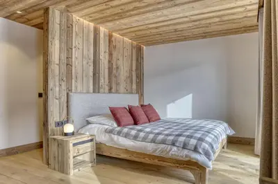 a bedroom with a bed with red pillows on it at Chalet Alpes in Combloux