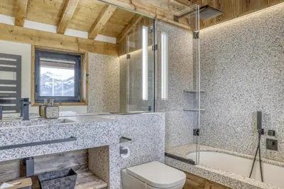 a bathroom with a toilet and a sink and a tub at Chalet Alpes in Combloux