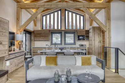 a living room with a couch and a table at Chalet Alpestre in Combloux