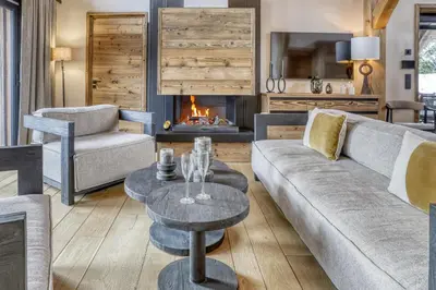 a living room with a couch and a fireplace at Chalet Alpestre in Combloux
