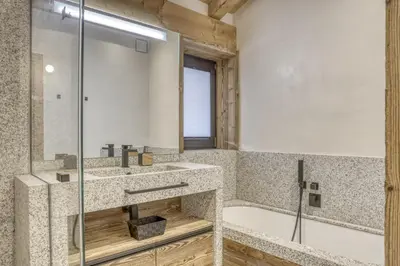 a bathroom with a shower and a sink and a tub at Chalet Alpestre in Combloux