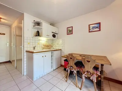 a kitchen with a wooden table in a room at Studio Le Flocon à Saint-Gervais-les-Bains in Saint-Gervais-les-Bains