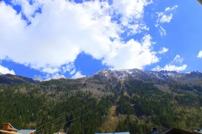 a view of a mountain with trees and a ski lift at Batiment F - A Chamonix Mont Blanc Panorama in Chamonix-Mont-Blanc