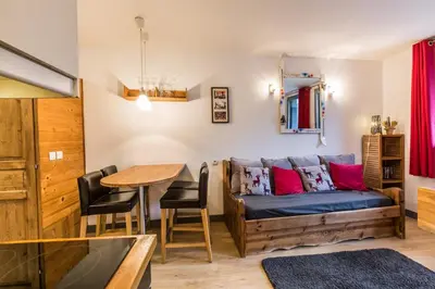 a living room with a couch and a table at Batiment F - A Chamonix Mont Blanc Panorama in Chamonix-Mont-Blanc