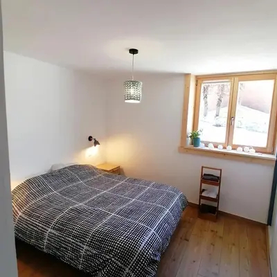 a bedroom with a bed and a window at Au petit Névé in Les Houches