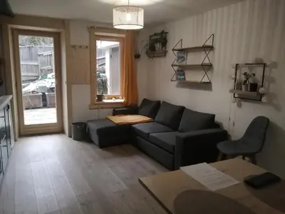 a living room with a couch and a table at Au petit Névé in Les Houches