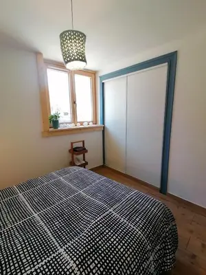 a bedroom with a large bed and a window at Au petit Névé in Les Houches