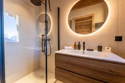 a bathroom with a sink and a mirror at Le Chalet Baan - avec vue sur les montagnes in Combloux