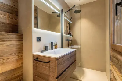 a bathroom with a sink and a mirror at Le Chalet Baan - avec vue sur les montagnes in Combloux