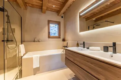 a bathroom with a tub and a sink at Le Chalet Baan - avec vue sur les montagnes in Combloux